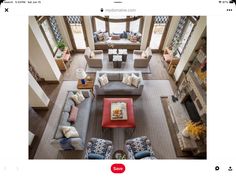 an aerial view of a living room with couches and tables in the middle of it