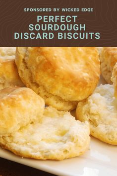 some biscuits on a white plate with the words perfect sourdough biscuits