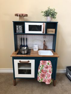 a toy kitchen with a sink and microwave