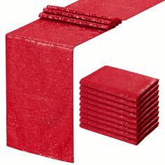 a stack of red napkins sitting next to each other on top of a white surface