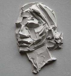 an image of a man's face made out of white paint on a gray background