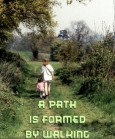 a woman walking down a path with a pink bag on her back and the words, a path is formed by walking