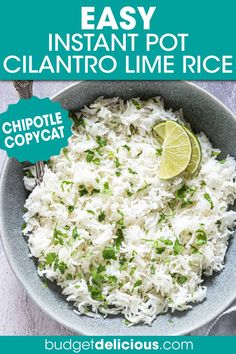 a bowl filled with white rice and garnished with cilantro limes