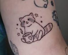 a small tattoo on the arm of a person with a cat and bird in it