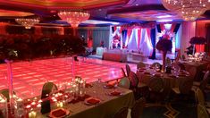 a dance floor is set up for an event with chandeliers and candles on it