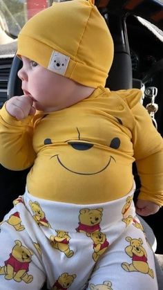 a baby wearing winnie the pooh pajamas