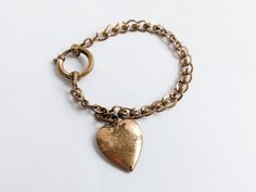 Beautiful ornate double loop effect curb chain link ladies love bracelet, in gilt brass, featuring an ornate heart charm and large oversized spring ring clasp. embossed with a 4 leaf 'lucky' clover. Unsigned, no markings. A traditional piece of Victorian era jewellery, which would make a lovely small gift for her. Circa late 1800s-early 1900s.  Measures approx 16.5 x 0.6cm open length. Designed for smaller wrists.  CONDITION: (Zoom in photos) Used antique - very good, clasp tested and works fine Vintage Oval Link Jewelry With Charms, Antique Brass Jewelry For Valentine's Day, Antique Brass Jewelry With Heart Charm, Vintage Gold Charm Bracelet With Heart Charm, Antique Engraved Chain Bracelet Gift, Vintage Bracelet Jewelry For Valentine's Day, Vintage Metal Charm Bracelet For Valentine's Day, Vintage Gold Bracelets For Valentine's Day, Antique Metal Jewelry With Curb Chain