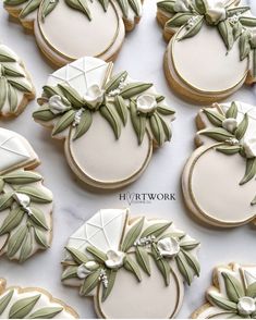 decorated cookies with green leaves and white flowers