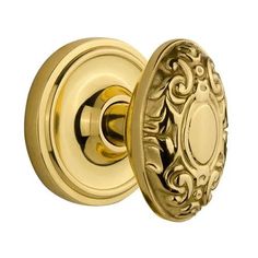 an ornate brass door knob with a decorative design on the front and back side,