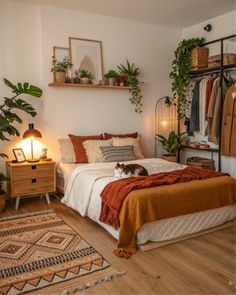 a bedroom with a bed, dresser and hanging plants