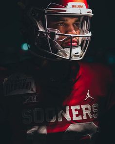 a football player wearing a helmet in the dark