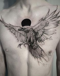 a man's chest with an eagle tattoo on it, and the moon in the background