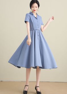 "This swing dress is a 50s inspired shirtwaist dress , featuring classic open neck, notched collar, and center front button closure, finished with a swing skirt, and handy side seam pockets. DETAILS * 50% linen ,50% cotton * Two seam pockets * Front Button up closure * Short sleeve * Notched collar * Below knee Length * Perfect for Spring, Summer * Wash by hand or machine with cold water * The model is 170cm (5′7″) tall with a 80cm (31.5\") bust, 66cm (26\") waist. She is wearing the blue dress 1950s Style Knee-length Dress With Button Closure, Classic Collared Solid Dresses, Classic Collared Dress, Classic Solid Collared Dresses, Dress With Collar Classy, 1950s Style Summer Dresses, Fitted Collared Light Blue Dress, Vintage A-line Dress For Office, Retro Spring Dresses For Office