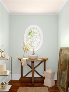 a bathroom with a round window and wooden floors