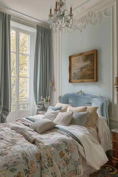 a bedroom with a chandelier hanging from the ceiling next to a bed in front of a window