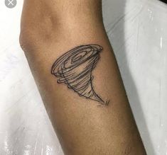 a woman's arm with a tattoo that has a small hat on the top