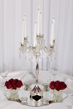 the centerpieces are arranged on top of each other, with roses in vases