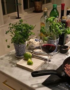 the kitchen counter is covered with spices, herbs and wine