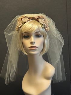 This little treasure is original, never used French 'BIBI' that I adapted as a bridal head piece. I guess the flowers are chrysanthemum  or carnation.Made in  several  shadows of beige, brown velvet ribbon and green leaves..  It's supper light it can be used in front, center  or back of the head. The veil is very short in dark ivory and it is  attached to the piece.  I did in Ivory to keep it just One Vision- Ivory.  I can  alter the length of the veil if you prefer a little longer. The veil is 23 in long.  This little head ornament is original from the 50s and it's very discrete, it's  a piece that goes with anything you're wearing. 1930s Veil, Vintage Cream Headpieces For Vintage Events, Vintage Headband Veil, Vintage Fitted Pink Headpiece, Vintage Cream Wedding Headpiece, Bridal Floral Headpiece, Little Hat, Grace Kelly Style, Rosé Brown