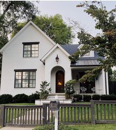 a white house with black shutters on the front