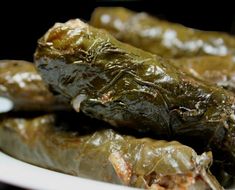 some stuffed green peppers on a white plate