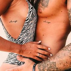 a man and woman with tattoos on their arms