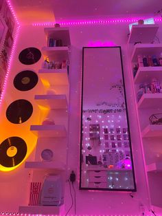 a room with record players and shelves filled with records, lights, and other items