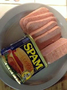 some food is on a plate near a can of soda and a bag of crackers