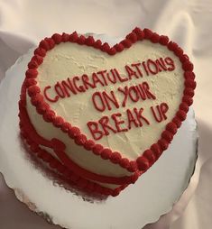 a heart shaped cake that says congratulations on your break up