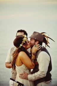 a man and woman kissing on the beach