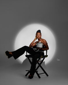 a woman sitting in a chair holding a cake