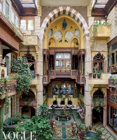 the inside of an old building with many windows and plants on the balconys,