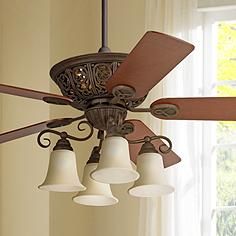 a ceiling fan with five lights hanging from it's blades in front of a window