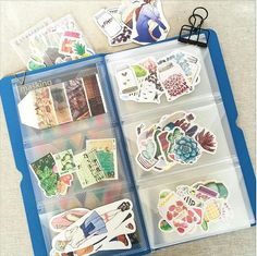 an open plastic box with various stickers in it