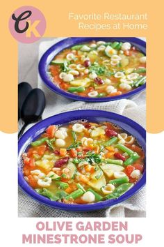 two blue bowls filled with pasta and veggies on top of a white table