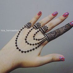 a woman's hand with henna tattoos on it