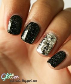 a person with black and silver nail polish on their nails