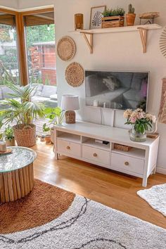 a living room filled with lots of furniture and decor on top of wooden flooring