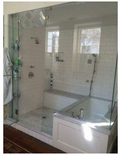 a bathroom with a walk in shower next to a bath tub