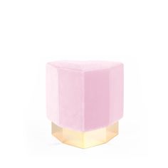 a pink and gold stool on a white background with the light shining through it's top