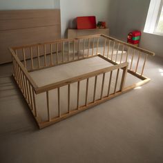 a wooden bed frame in a room with beige carpet