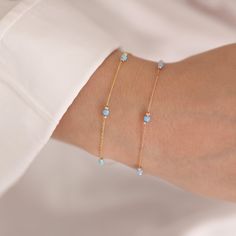 Enhance your look with this 14k Gold Light Blue Opal Round Bracelet, which comes in three opal colors: immaculate white opal, peaceful light blue opal, and intriguing dark blue opal. Each opal represents October's birthstone and possesses distinct characteristics, making this bracelet an ideal birthday gift or accessory for Libras.  This bracelet oozes elegance and grace because to its link to Venus, the goddess of love and beauty. Choose the light blue opal for a quiet and soothing impression, Venus Jewelry, Round Bracelet, Minimal Bracelet, Minimal Gifts, Bracelet Elegant, Zodiac Bracelet, Jewellery Marketing, Opal Color, Opal Bracelet