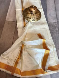 This listing has options for mundu sets for men with and without angavastram. The fabric is a superb semi silk and looks just like a pure silk set and zari is half fine. There are 2 options - one with a 1.75 inches zari border and another with a small 0.75 inches zari border. Angavastra is attached to the silk dhoti set and is running. Panche Shirt For Men, Ceremonial Cotton Silk Sets With Traditional Drape, Traditional Drape Wear With Dabka For Puja, Cotton Silk Churidar For Ceremonial Festivals, Ceremonial Cotton Silk Churidar For Festivals, White Chanderi Sherwani For Puja, Dabka Embellished Traditional Wear For Festivals, White Self-design Sherwani For Puja, White Sherwani With Self Design For Puja