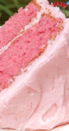 a slice of pink cake sitting on top of a white plate