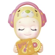 a small toy with headphones on holding a record in it's hands,