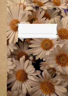 a bunch of white and brown flowers with a paper strip in the middle that says i love you