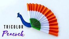 an orange, white and green paper fan with the words tricolor peacock on it