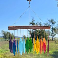 a wind chime hanging in the air with colorful surfboards on it's strings