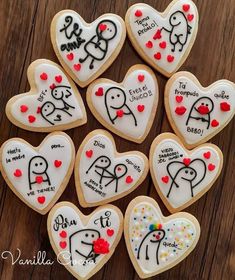 decorated cookies in the shape of hearts with writing on them