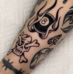 a man's arm with tattoos on it and a skull in the middle,